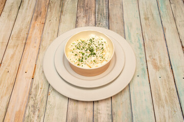 Potatoes cooked with aioli sauce. Typical tapas of Spanish restaurants on wooden table