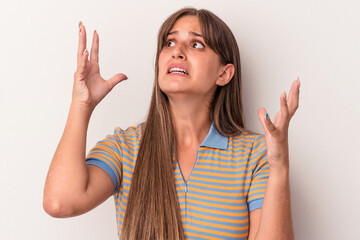 Young caucasian woman isolated on white background screaming to the sky, looking up, frustrated.