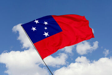 Samoa flag isolated on the blue sky background. close up waving flag of Samoa. flag symbols of Samoa. Concept of Samoa.