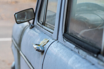 Retro handle with lock on vintage car close up, blurred background