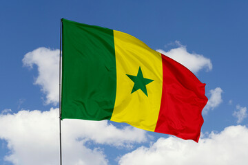 Senega flag isolated on the blue sky background. close up waving flag of Senega. flag symbols of Senega. Concept of Senega.