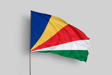 Seychelles flag isolated on the blue sky background. close up waving flag of Seychelles. flag symbols of Seychelles. Concept of Seychelles.