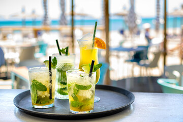 a selection of freshly made tropical alcoholic cocktails ready to serve and drink in a beach bar along the Mediterranean coastline. 