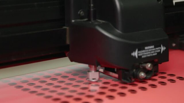 A wide shot of a plotter cutting out round stickers.