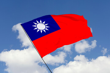 Taiwan flag isolated on the blue sky background. close up waving flag of Taiwan. flag symbols of Taiwan. Concept of Taiwan.