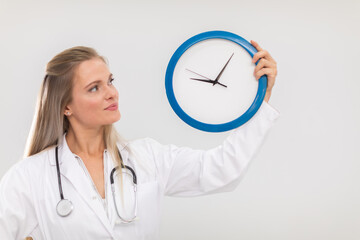 The doctor holds a wall clock in her hands and reminds you that it's time to treat.