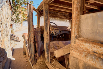 Fototapeta na wymiar Old car with rust abandoned on the street