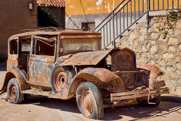 Old car with rust abandoned on the street