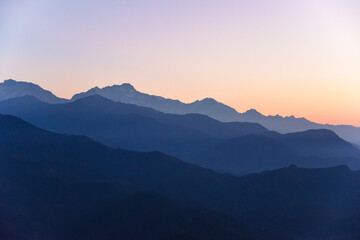 Beautiful shot of layers of mountains range at sunset