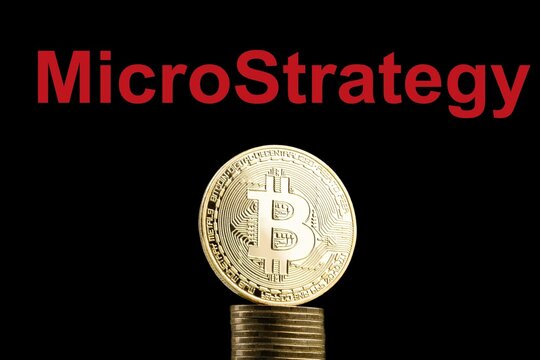 Bitcoin BTC representation coin with MicroStrategy text in background.