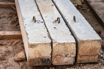 Reinforced concrete beams for building structures stacked at a construction site.