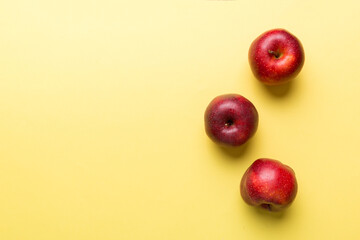 Many red apples on colored background, top view. Autumn pattern with fresh apple above view with copy space for design or text