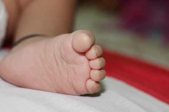 Foot photo of a small innocent newborn baby