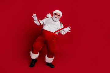 Fototapeta na wymiar Photo of crazy man dance december x-mas event performance wear santa hat costume isolated red color background