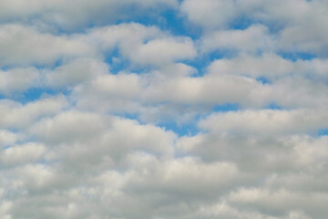 Clouds in the blue sky. Image that conveys serenity and tranquility. Idea of dream and paradise