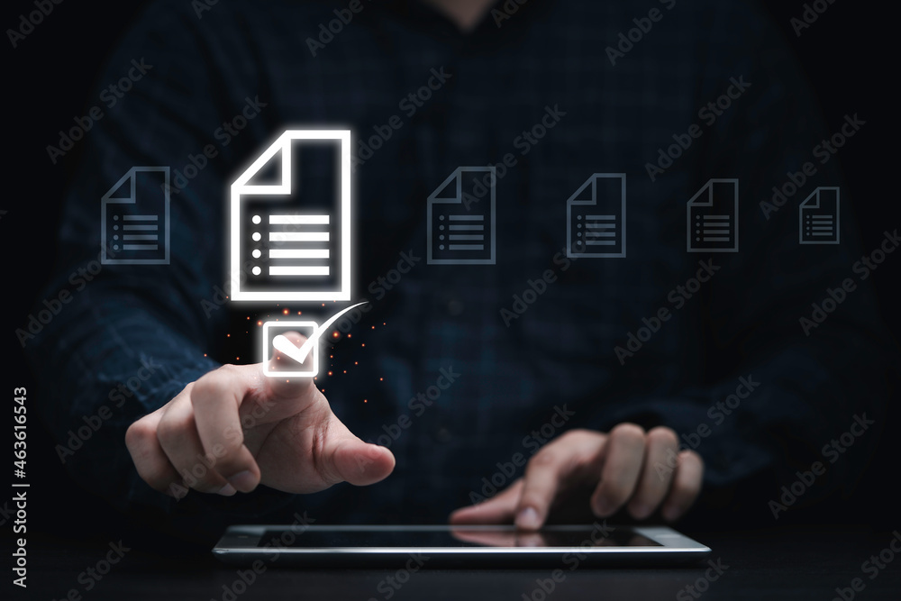 Poster Businessman using tablet and touching on document icon for approve and online document concept.