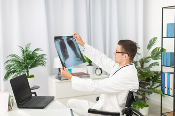 In a hospital office, a pulmonology physician checks a patient's lung x-ray.