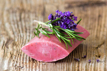 bar of natural soap, lavender flowers and rosemary