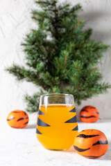 orange mandarin cocktail in glass with black stripes. Christmas holiday welcome drink. Concept for children new year