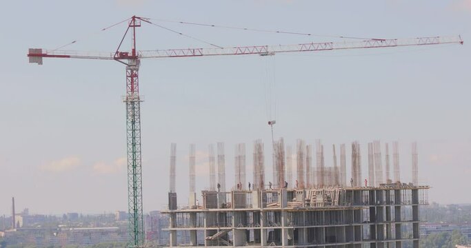 Construction of a multi-storey residential building. Tower crane at a construction site. Construction crane at a construction site