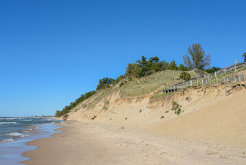 Fototapeta na wymiar Relaxing beach dunes with empty blue sky