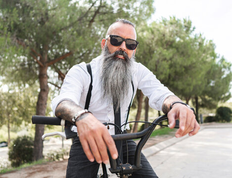 Bearded hipster man on bicycle