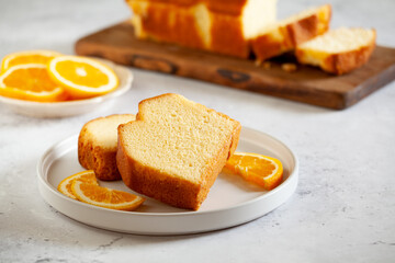 Slices of homemade cake with oragnic oranges