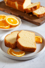 Slices of homemade cake with oragnic oranges