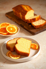 Slices of homemade cake with oragnic oranges
