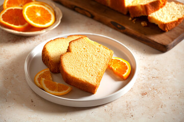 Slices of homemade cake with oragnic oranges