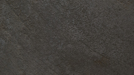 Textured gray concrete background. Old wall or floor made of dark gray cement. Scuffed and cracked....
