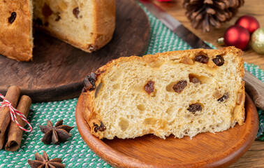 Traditional italian christmas fruit cake panettone with slice and christmas decoration