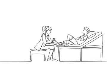 Fototapeta premium Single one line drawing doctor bandage broken leg to little boy patient sitting on couch. Kid with plaster on ankle in hospital room. Trauma, healthcare, therapy. Continuous line draw design vector