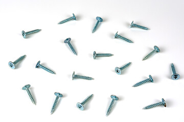 abstract background. shiny self-tapping screws for metal on a white background