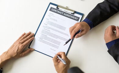Business people signing a contract agreement. Concept of legal and business agreement signing.