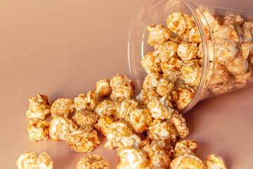 sweet caramel popcorn and plastic cup close-up