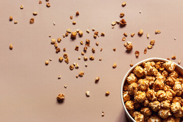 popcorn in paper packaging and crumbs scattered on the background