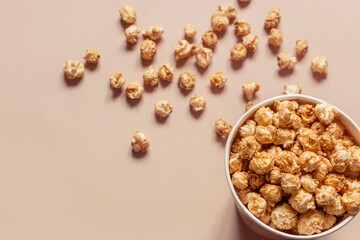 popcorn in paper packaging and scattered on the background