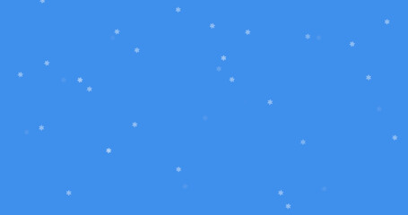 Glowing snow particles falling against blue background