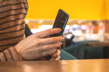 Woman hide the mobile phone in cafe. Coffee break is over, time is out concept photo