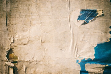 Fototapeta na wymiar Old ripped torn posters background creased crumpled grungy paper backdrop urban street placard
