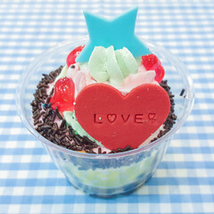 Colorful cupcake on blue plaid tablecloth