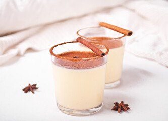 Glasses of holiday egg nog on the white background