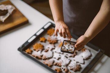 Woman takes photo on smartphone Christmas gingerbread sprinkled with powdered sugar.