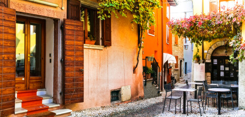 Charming old narrown streets of Italian villages. Malcesine, Garda lake, Italy. Autumn colors urban scenery