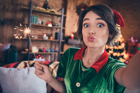 Photo of affectionate lady hold bengal fire shoot selfie send air kiss wear elf costume in decorated home indoors