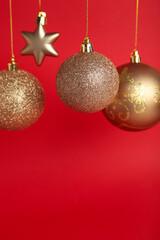 Golden christmas balls on red background with copy space. New Year 2022