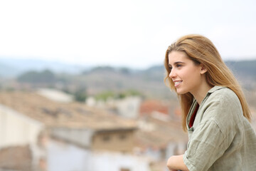 Happy teen looking away from balcony