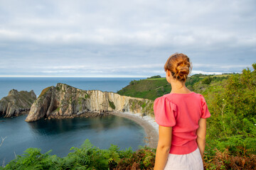 Woman contemplating a beautiful coast