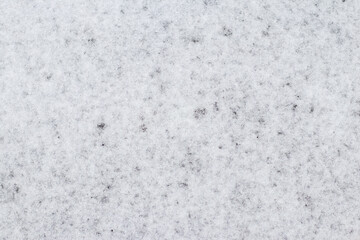 Fototapeta na wymiar Winter background with wet loose snow, snow texture